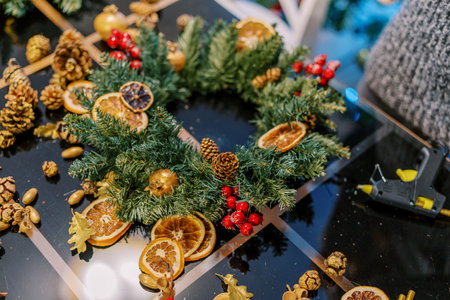 Artist stands near the Christmas wreath on the table. Cropped. Facelessの写真素材