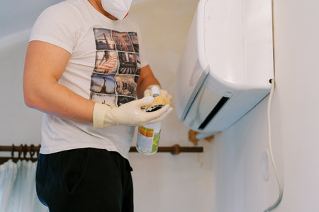 Cleaner in gloves wetting sponge with anti-mold solution