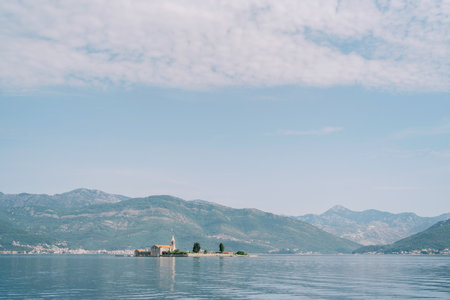 Island of Gospa od Milosti in the Tivat Bay against the backdrop of mountains. Montenegroの写真素材