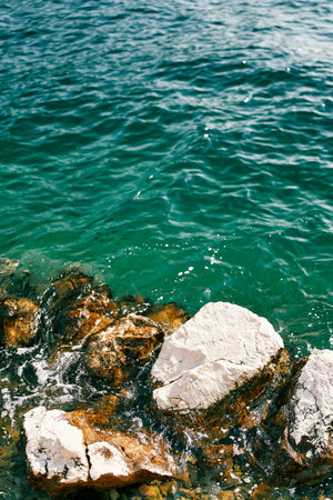 Sea waves roll on coastal rocksの写真素材