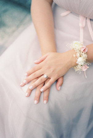 Bride sits with her hands folded on her lap. Cropped. Facelessの写真素材