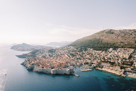 Ancient port of Dubrovnik with castle walls on the seashore at the foot of the mountains. Croatia. Droneの写真素材