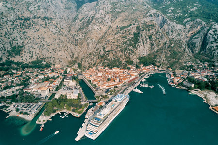 Huge cruise ship is moored in the port of the town of Kotor. Montenegro. Droneの写真素材