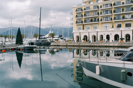 Motor yachts stand at the pier with a decorated Christmas tree near the Regent Hotel. Porto, Montenegroの写真素材