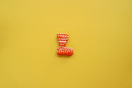 Gingerbread boot lies on a yellow backgroundの写真素材