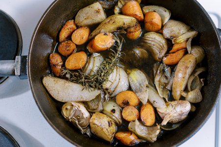 Chopped vegetables with spices are stewed in a frying pan on the stove. Top viewの写真素材