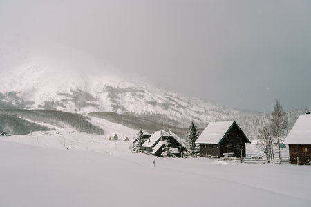 Snow-covered cozy village in a mountain valley. Durmitor National Park, Montenegroの写真素材