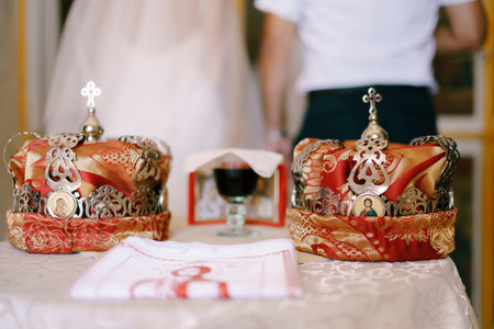Two wedding crowns are on the table in the churchの写真素材