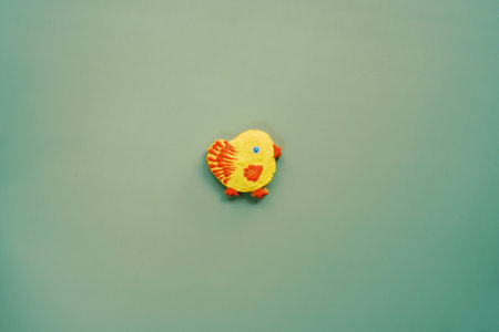 Yellow cookie-chicken in the middle on a green backgroundの写真素材