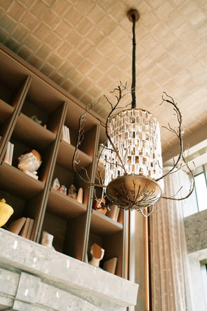 Modern chandelier with pendants and branches hanging on a high ceilingの写真素材