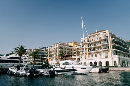 Motor yachts are moored offshore near the hotel. Porto, Montenegroの写真素材