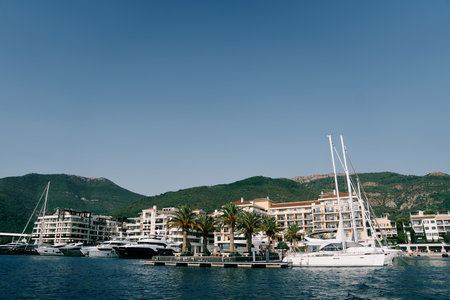 Motor yachts are moored along the pier opposite the Regent Hotel. Porto, Montenegroの写真素材
