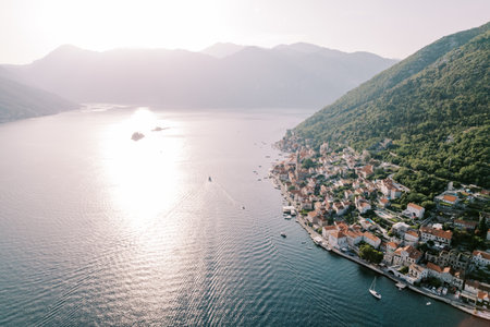 Sea sparkling in the sun off the coast of Perast between the mountains. Montenegro. Droneの写真素材