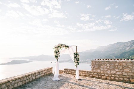 Rectangular wedding arch stands on an observation deck in the mountains above the seaの写真素材
