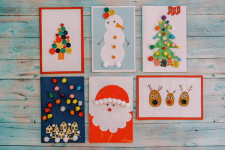 Festive New Year cards lie on a wooden tableの写真素材