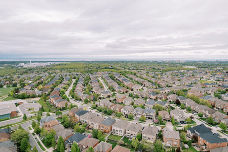 Panoramic drone shot capturing planned neighborhood with scenic natural features and streets