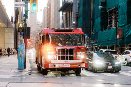 Toronto, Canada - June 20, 2026: Fire truck with flashing lights on King Street West downtown