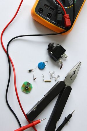 Various radio components, the tool and the measuring tool on a white background. Electrical...