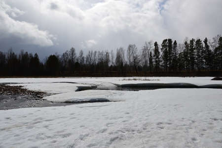 Ice on the river melts. Landscape on a cloudy day.の写真素材