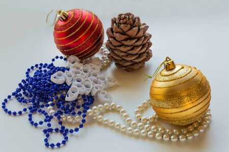 Christmas composition. Christmas balls, beads, pine cones and paper snowflakes in the style of quilling.の写真素材