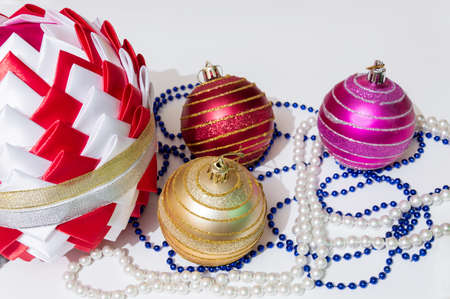 Interior decorations for the New year or Christmas. Colored beads and glass balls, a large handmade ball in Japanese Kanzashi style on a white background.の写真素材