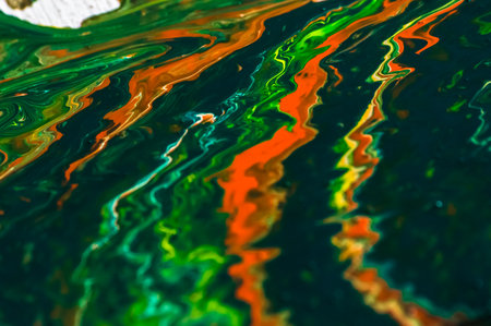 Abstract background of acrylic paint in green and orange colors, macro photographyの写真素材