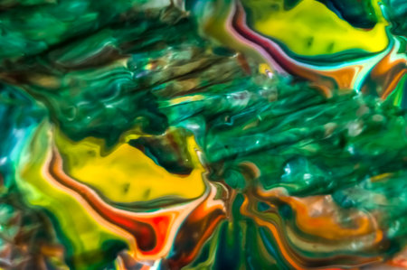 Abstract background of watercolor paints in green, orange and yellow colors