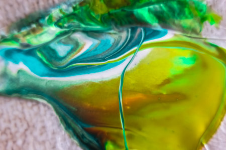 Abstract background of yellow, green and blue acrylic paints in water