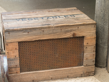 old fashioned wooden crate with mesh front side used for vegetables shipment