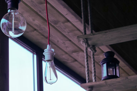 Vintage light bulb hanging on the ceiling of the cafe, stock photo