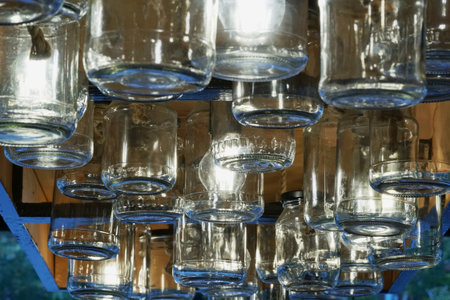 A lot of empty glasses on a shelf in a store, close-upの写真素材