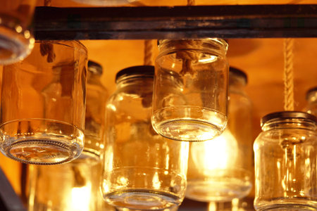 Glass jars on a shelf in a restaurant, closeup of photo