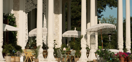 Outdoor terrace with tables, chairs and umbrellas.
