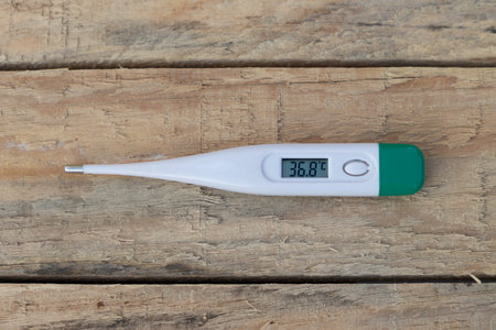body temperature meter on a wooden table