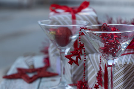 two martini glasses surrounded by new year giftsの写真素材