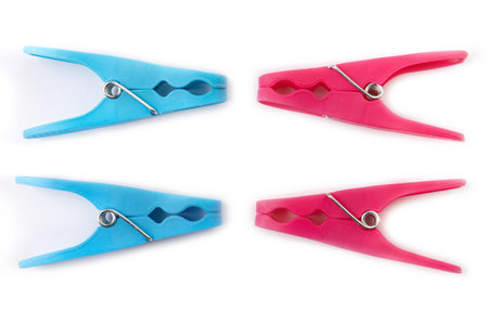 top view of four different color clothespins isolated on white backgroundの写真素材