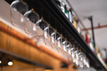 glasses and bottles with alcohol on top of a bar in a restaurantの写真素材