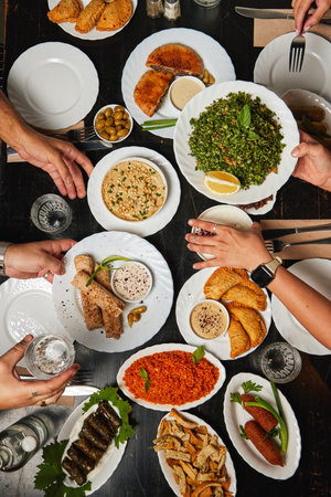 traditional Palestinian, arabic food top view with hands in a restaurantの写真素材