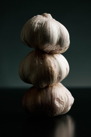three garlics on a black table. High qualityの写真素材