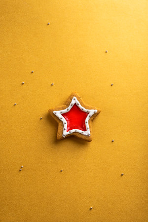 Christmas gingerbread with icing on a gold background. Christmas pastries.