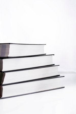 Pile of books, side view, on white isolated backgroundの写真素材