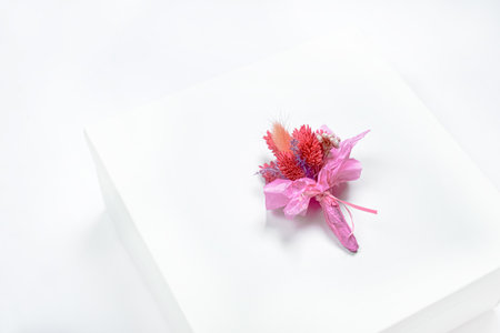 Top view of small cute red statice flower on white blank paper on blue background in vintage tone