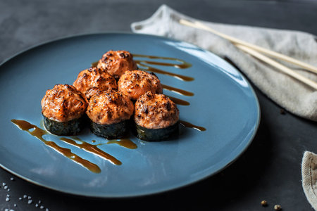 Japanese sushi close-up. Top view on a blue plate, dark gray background.の写真素材