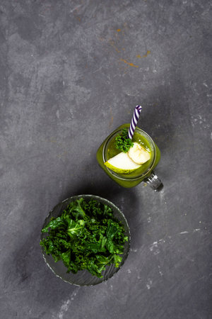 Green cabbage and flaxseed smoothie, top view. Dark gray textured vertical background. Space for text, Copyspace.の写真素材