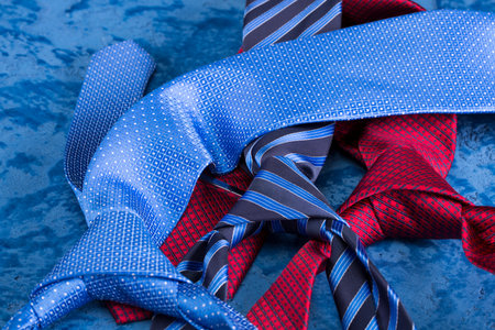 Three tie of silk on a blue background. red. blue. striped.