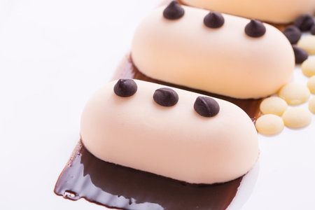 Creamy dessert with grains of white and dark chocolateの写真素材