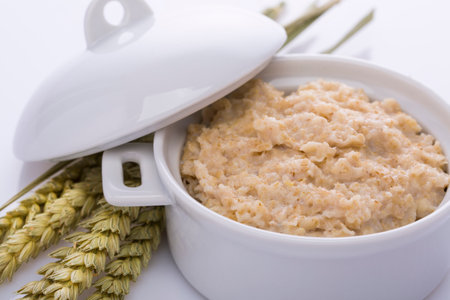Oatmeal and bran in a white pot. Healthy food.の写真素材