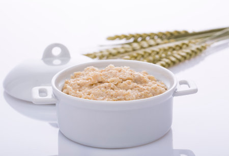 Oatmeal and bran in a white pot. Healthy food.の写真素材