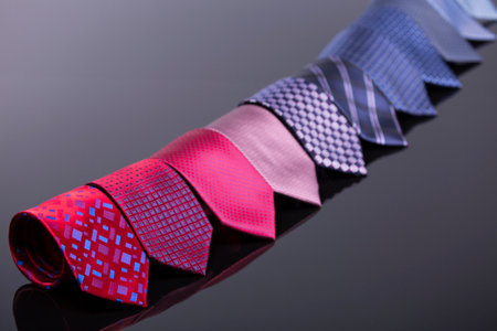 silk ties in different colors, spread out on a black tablの写真素材