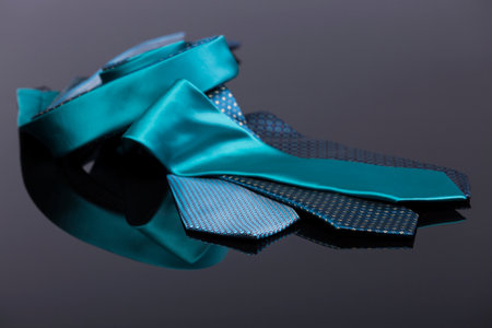 silk ties in different colors, spread out on a black tablの写真素材